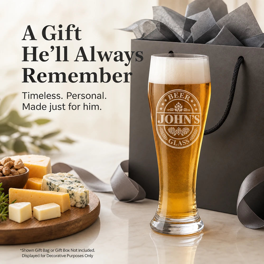 16 oz pilsner beer glass with white personalized engraving next to an illustrative gift bag not included